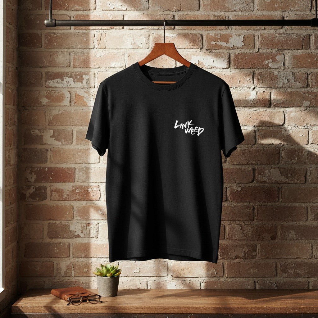 LINKWEED black cotton t-shirt with white graffiti-style logo on the left chest. Standard fit, short sleeves.