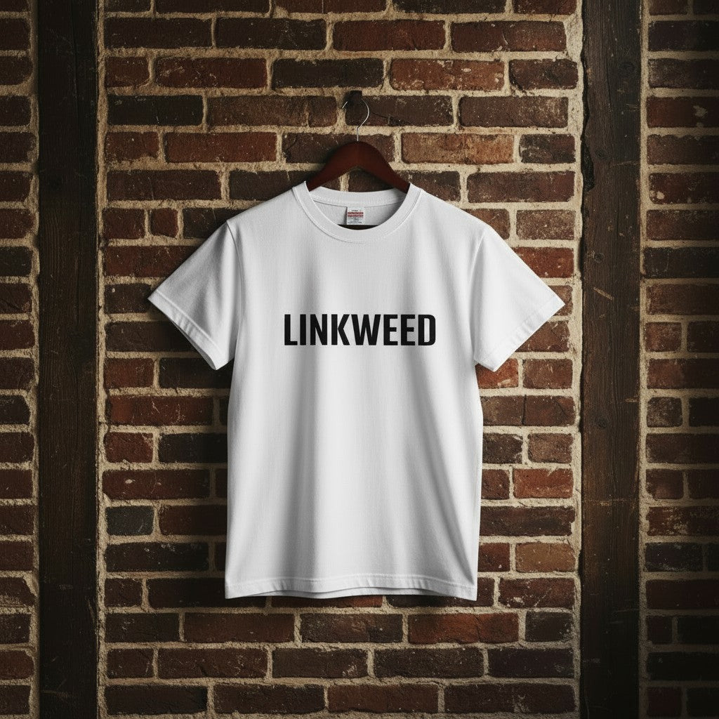 LINKWEED white cotton t-shirt with black text logo, standard fit, hanging on a brick wall.